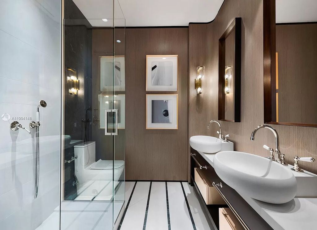 The Miami Beach Home is a new residence designed by world design star Achille Salvagni with a 90 ft infinity pool and private boat dock now available for sale. This home located at 810 Lakeview Dr, Miami Beach, Florida; offering 7 bedrooms and 7 bathrooms with over 7,900 square feet of living spaces.