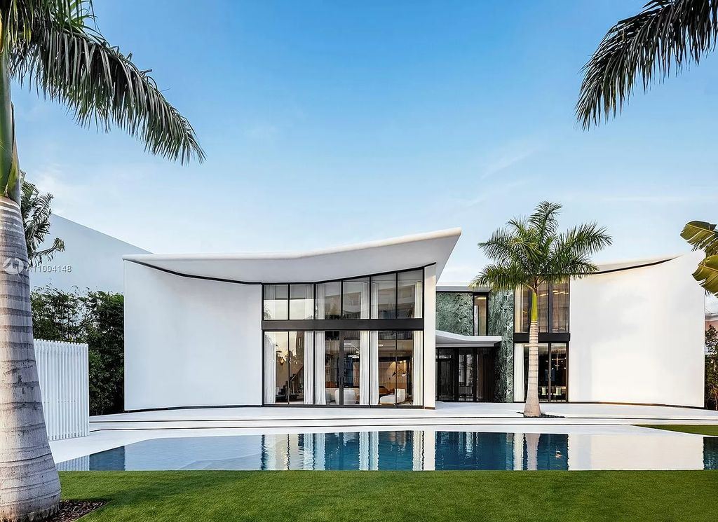 The Miami Beach Home is a new residence designed by world design star Achille Salvagni with a 90 ft infinity pool and private boat dock now available for sale. This home located at 810 Lakeview Dr, Miami Beach, Florida; offering 7 bedrooms and 7 bathrooms with over 7,900 square feet of living spaces.