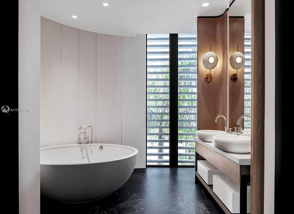 The Miami Beach Home is a new residence designed by world design star Achille Salvagni with a 90 ft infinity pool and private boat dock now available for sale. This home located at 810 Lakeview Dr, Miami Beach, Florida; offering 7 bedrooms and 7 bathrooms with over 7,900 square feet of living spaces.