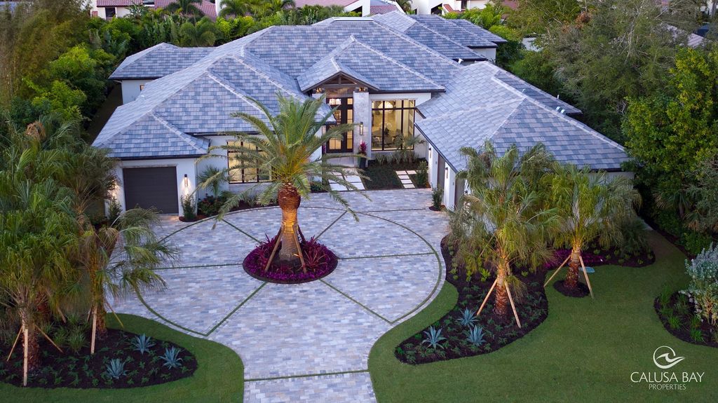 The Contemporary Home is perfectly complemented by lush mature tropical landscaping in the heart of Pelican Bay now available for sale. This home located at 810 Bentwood Dr, Naples, Florida; offering 4 bedrooms and 6 bathrooms with over 4,600 square feet of living spaces.