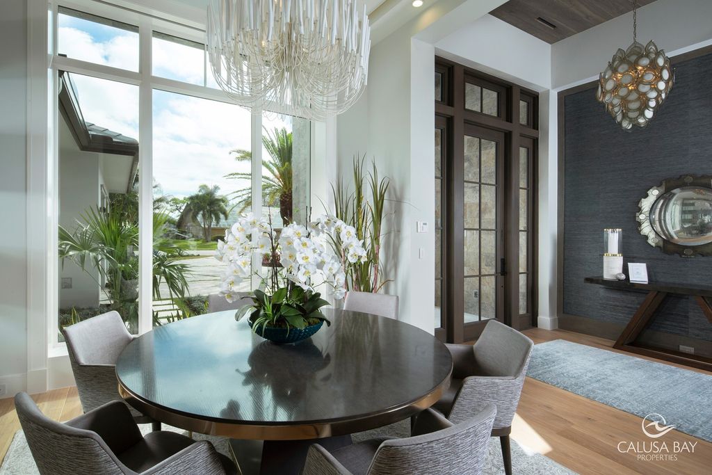 The Contemporary Home is perfectly complemented by lush mature tropical landscaping in the heart of Pelican Bay now available for sale. This home located at 810 Bentwood Dr, Naples, Florida; offering 4 bedrooms and 6 bathrooms with over 4,600 square feet of living spaces.