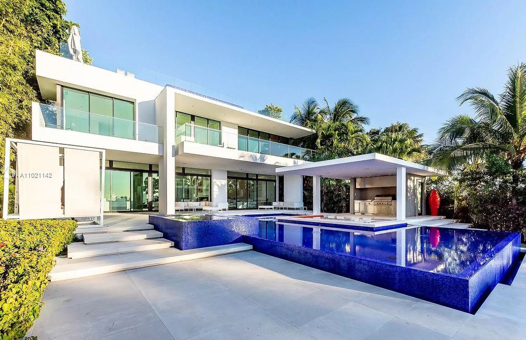 The Resort Style Mansion in Miami Beach is a newly luxurious home with sunsets over the Miami skyline on prestigious North bay road now available for sale. This home located at 5004 N Bay Rd, Miami Beach, Florida; offering 8 bedrooms and 10 bathrooms with over 12,800 square feet of living spaces. 