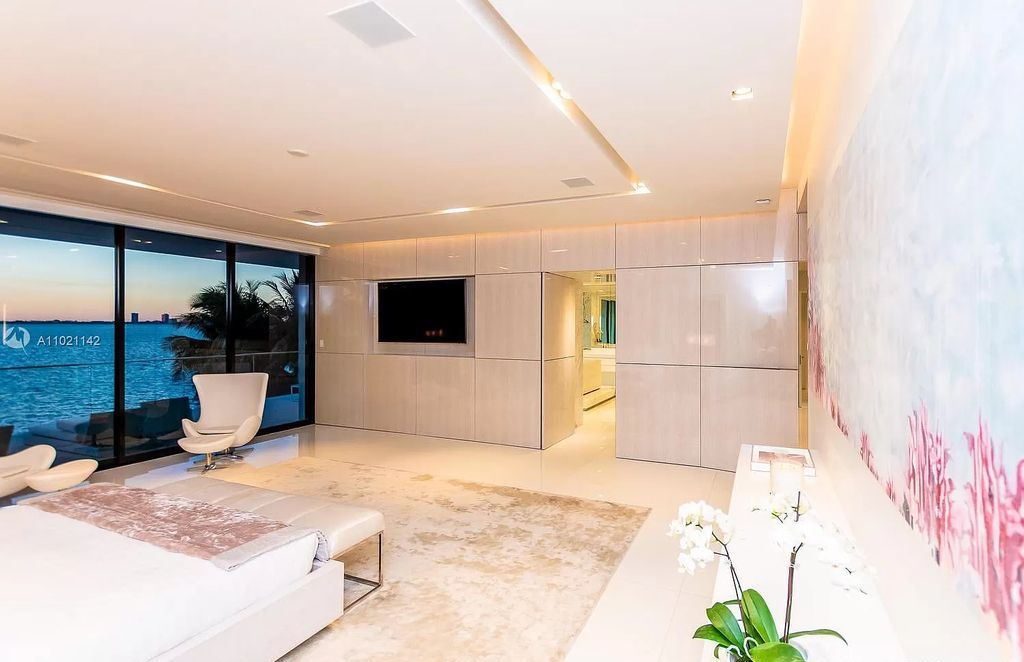 The Resort Style Mansion in Miami Beach is a newly luxurious home with sunsets over the Miami skyline on prestigious North bay road now available for sale. This home located at 5004 N Bay Rd, Miami Beach, Florida; offering 8 bedrooms and 10 bathrooms with over 12,800 square feet of living spaces. 