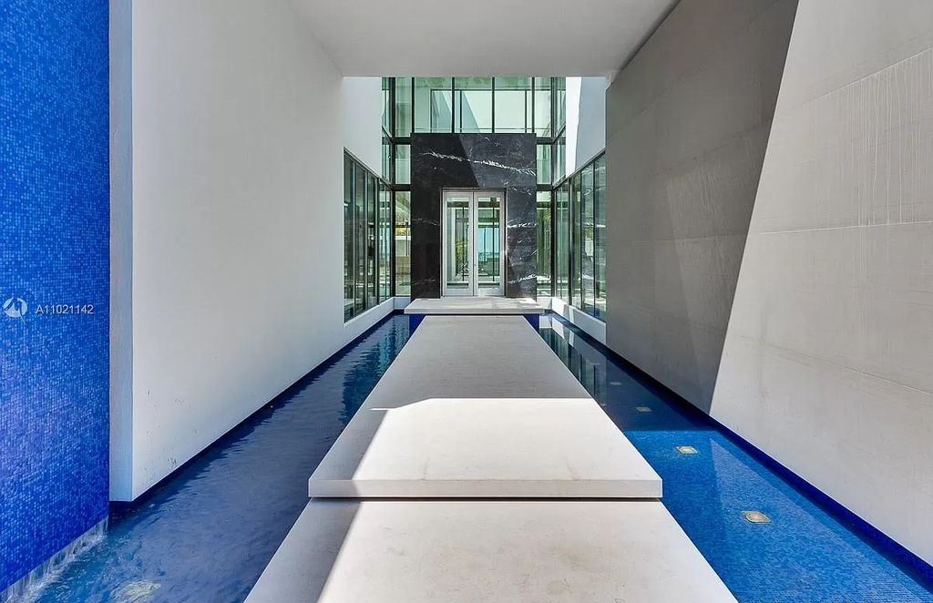 The Resort Style Mansion in Miami Beach is a newly luxurious home with sunsets over the Miami skyline on prestigious North bay road now available for sale. This home located at 5004 N Bay Rd, Miami Beach, Florida; offering 8 bedrooms and 10 bathrooms with over 12,800 square feet of living spaces. 