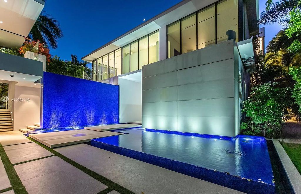 The Resort Style Mansion in Miami Beach is a newly luxurious home with sunsets over the Miami skyline on prestigious North bay road now available for sale. This home located at 5004 N Bay Rd, Miami Beach, Florida; offering 8 bedrooms and 10 bathrooms with over 12,800 square feet of living spaces. 