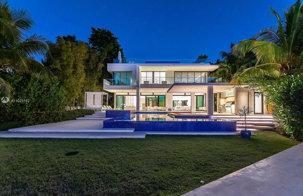 The Resort Style Mansion in Miami Beach is a newly luxurious home with sunsets over the Miami skyline on prestigious North bay road now available for sale. This home located at 5004 N Bay Rd, Miami Beach, Florida; offering 8 bedrooms and 10 bathrooms with over 12,800 square feet of living spaces. 