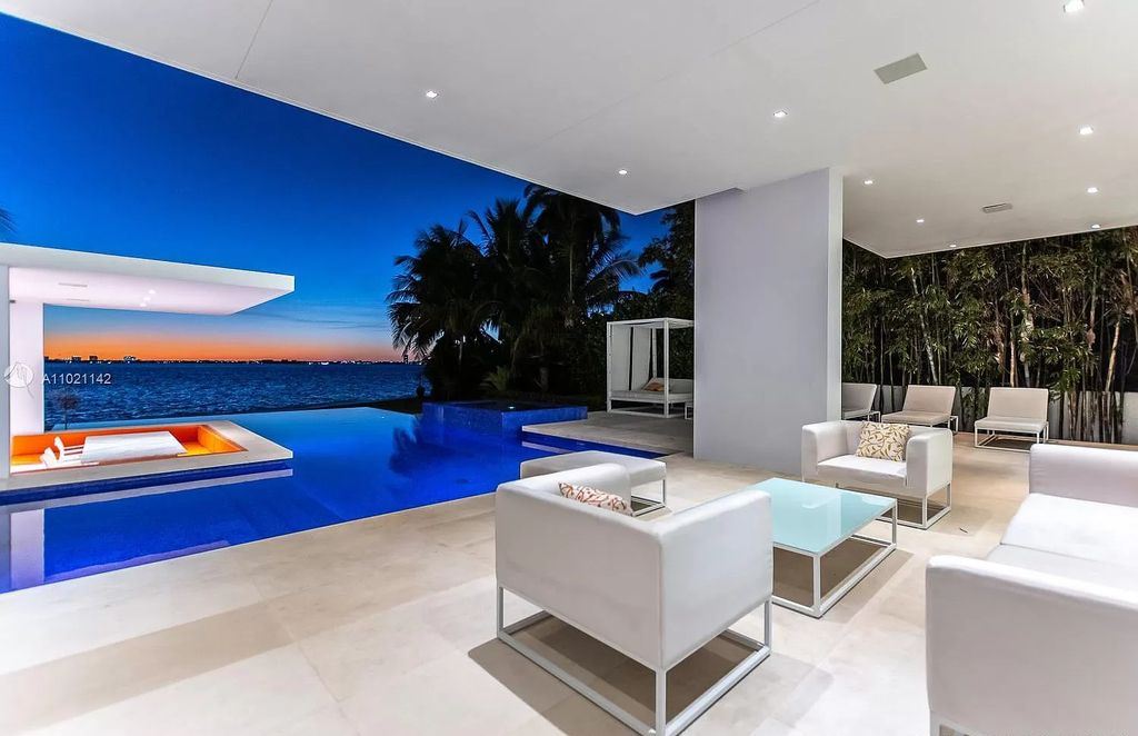 The Resort Style Mansion in Miami Beach is a newly luxurious home with sunsets over the Miami skyline on prestigious North bay road now available for sale. This home located at 5004 N Bay Rd, Miami Beach, Florida; offering 8 bedrooms and 10 bathrooms with over 12,800 square feet of living spaces. 