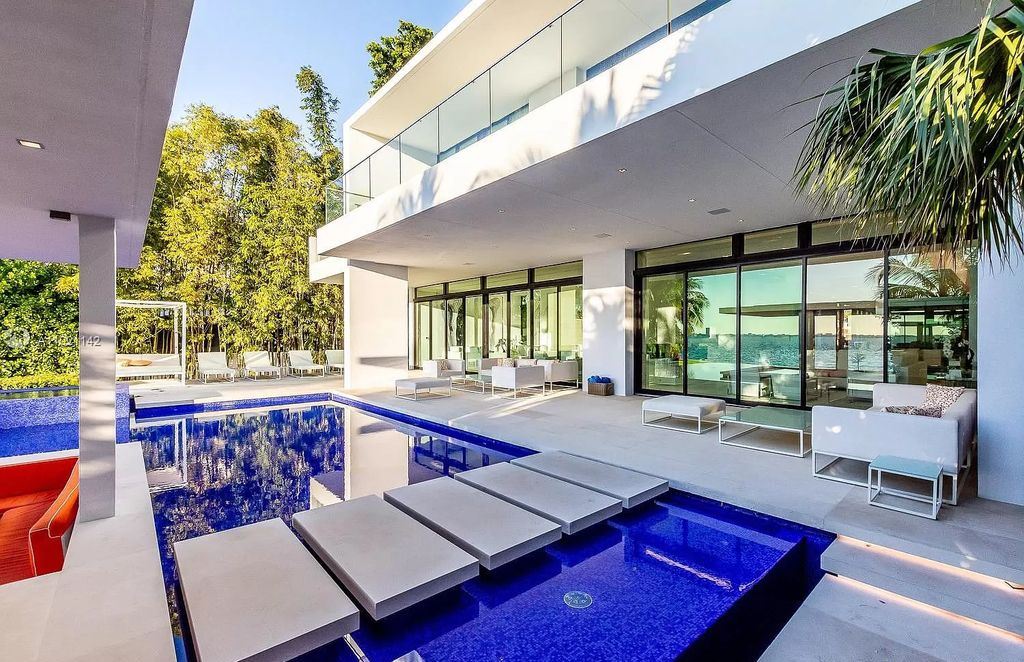 The Resort Style Mansion in Miami Beach is a newly luxurious home with sunsets over the Miami skyline on prestigious North bay road now available for sale. This home located at 5004 N Bay Rd, Miami Beach, Florida; offering 8 bedrooms and 10 bathrooms with over 12,800 square feet of living spaces. 