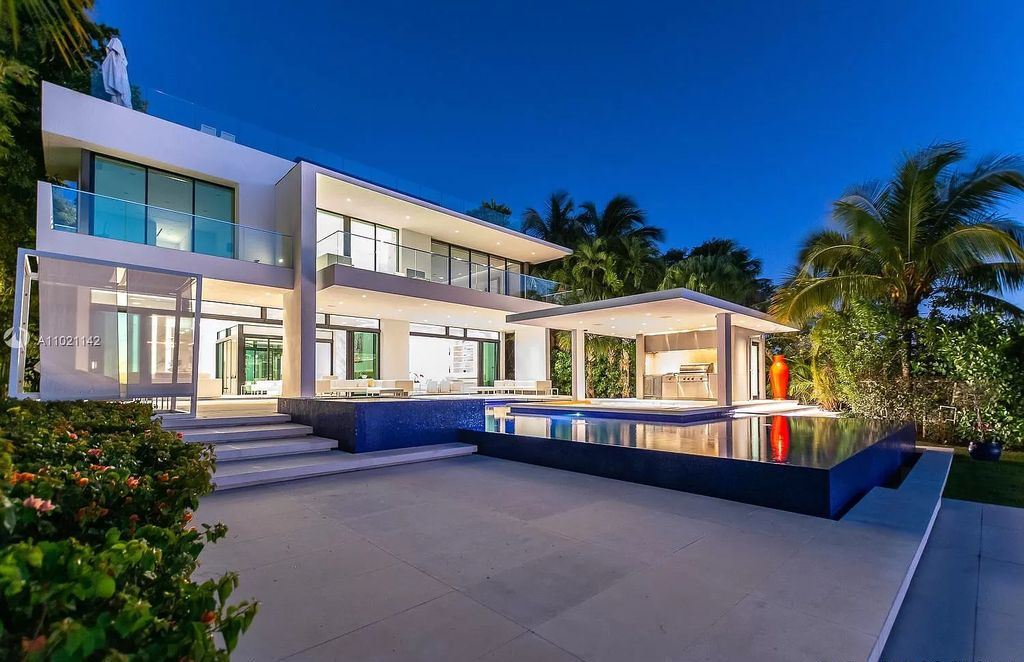 The Resort Style Mansion in Miami Beach is a newly luxurious home with sunsets over the Miami skyline on prestigious North bay road now available for sale. This home located at 5004 N Bay Rd, Miami Beach, Florida; offering 8 bedrooms and 10 bathrooms with over 12,800 square feet of living spaces. 