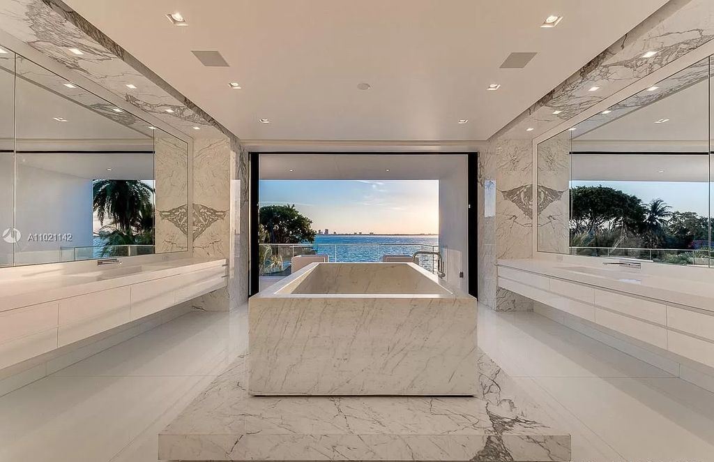 The Resort Style Mansion in Miami Beach is a newly luxurious home with sunsets over the Miami skyline on prestigious North bay road now available for sale. This home located at 5004 N Bay Rd, Miami Beach, Florida; offering 8 bedrooms and 10 bathrooms with over 12,800 square feet of living spaces. 