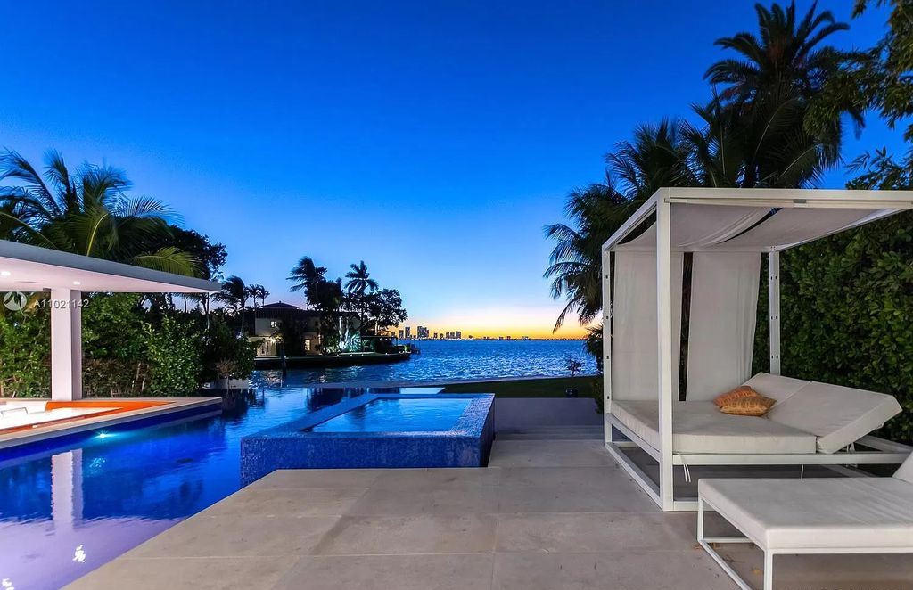 The Resort Style Mansion in Miami Beach is a newly luxurious home with sunsets over the Miami skyline on prestigious North bay road now available for sale. This home located at 5004 N Bay Rd, Miami Beach, Florida; offering 8 bedrooms and 10 bathrooms with over 12,800 square feet of living spaces. 