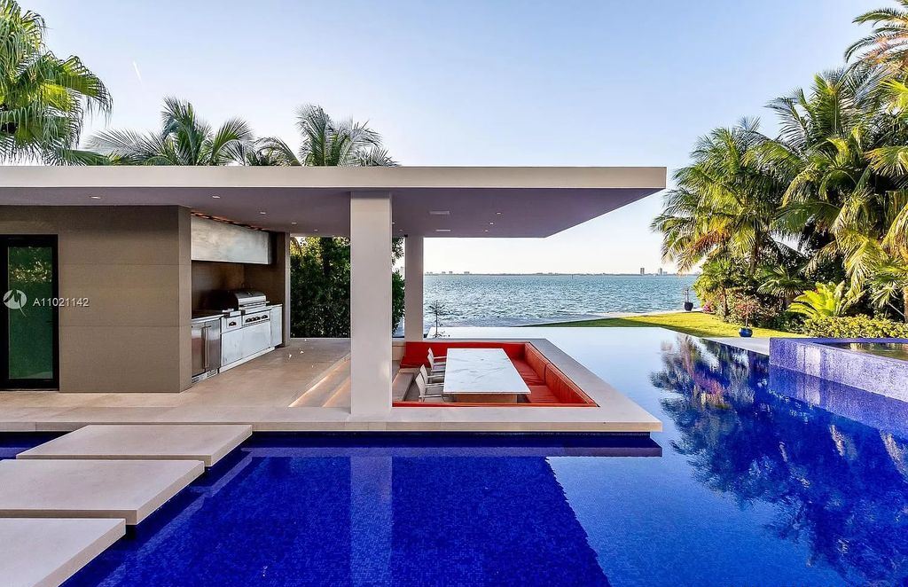 The Resort Style Mansion in Miami Beach is a newly luxurious home with sunsets over the Miami skyline on prestigious North bay road now available for sale. This home located at 5004 N Bay Rd, Miami Beach, Florida; offering 8 bedrooms and 10 bathrooms with over 12,800 square feet of living spaces. 