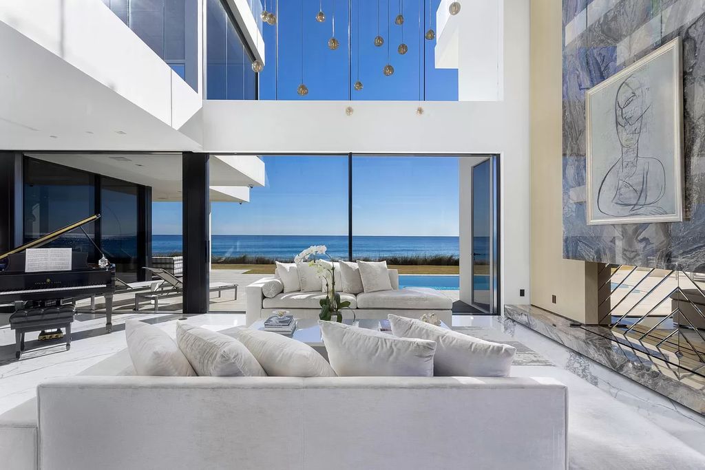 The Modern Mansion in Highland Beach is a gated modern Malibu-inspired ocean to intracoastal Estate now available for sale. This home located at 3833 S Ocean Blvd, Highland Beach, Florida; offering 5 bedrooms and 9 bathrooms with over 8,800 square feet of living spaces.