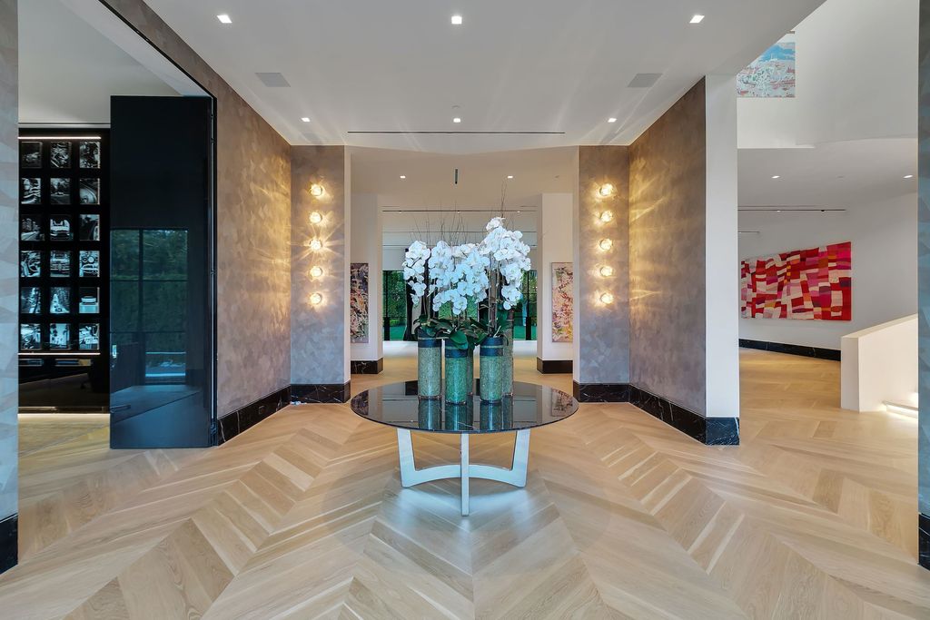 The World Class Trophy Mansion in Los Angeles is a warm contemporary French Manor set in the heart of Old Bel Air now available for sale. This home located at 10701 Bellagio Rd, Los Angeles, California; offering 8 bedrooms and 12 bathrooms with over 24,000 square feet of living spaces.