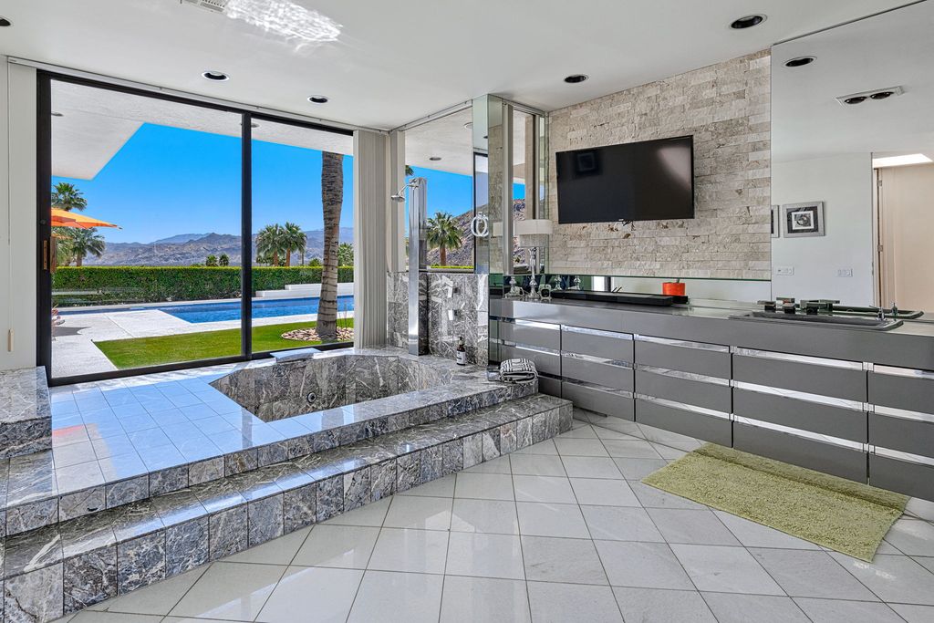 The Palm Springs Hills Modern Home is a iconic estate by John Walling and McCallum with incredible mountain and valley views now available for sale. This home located at 700 W Stevens Rd, Palm Springs, California; offering 6 bedrooms and 8 bathrooms with over 13,000 square feet of living spaces.