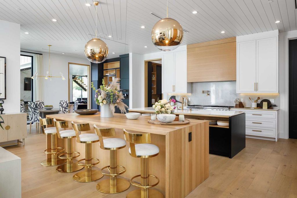 The Modern Farmhouse in Encino is a marvel at the grand scale, gorgeous fixtures, layered textures, and sleek design now available for sale. This home located at 17015 Adlon Rd, Encino, California; offering 6 bedrooms and 10 bathrooms with over 8,900 square feet of living spaces. 