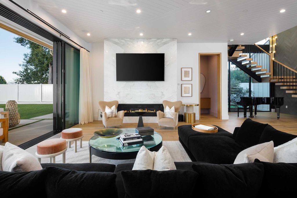 The Modern Farmhouse in Encino is a marvel at the grand scale, gorgeous fixtures, layered textures, and sleek design now available for sale. This home located at 17015 Adlon Rd, Encino, California; offering 6 bedrooms and 10 bathrooms with over 8,900 square feet of living spaces. 