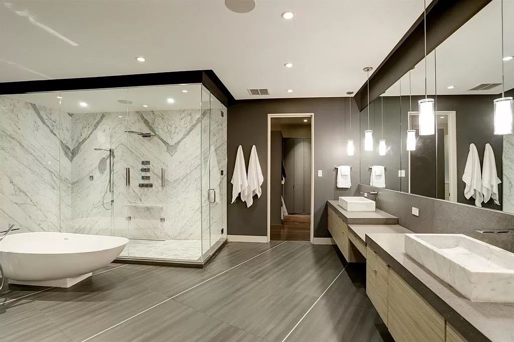 The masterful custom home in Houston offers modern contemporary detail and clean-line architecture mixed with the warmth of modern construction now available for sale. This home located at 4001 Ella Lee Ln, Houston, Texas; offering 4 bedrooms and 6 bathrooms with over 6,300 square feet of living spaces.