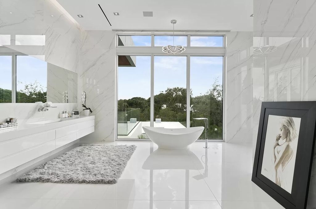 The Florida Contemporary Mansion is a luxurious masterpiece in the highly sought after enclave of Seminole Landing now available for sale. This home located at 1104 Seminole Blvd, North Palm Beach, Florida; offering 7 bedrooms and 8 bathrooms with over 17,000 square feet of living spaces. 