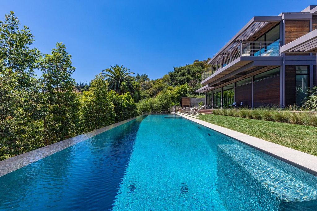 The Beverly Hills Home is a gated and secluded sanctuary with staggering vista views personifies quintessential California living now available for sale. This home located at 9321 Cherokee Ln, Beverly Hills, California; offering 5 bedrooms and 5 bathrooms with over 4,000 square feet of living spaces.