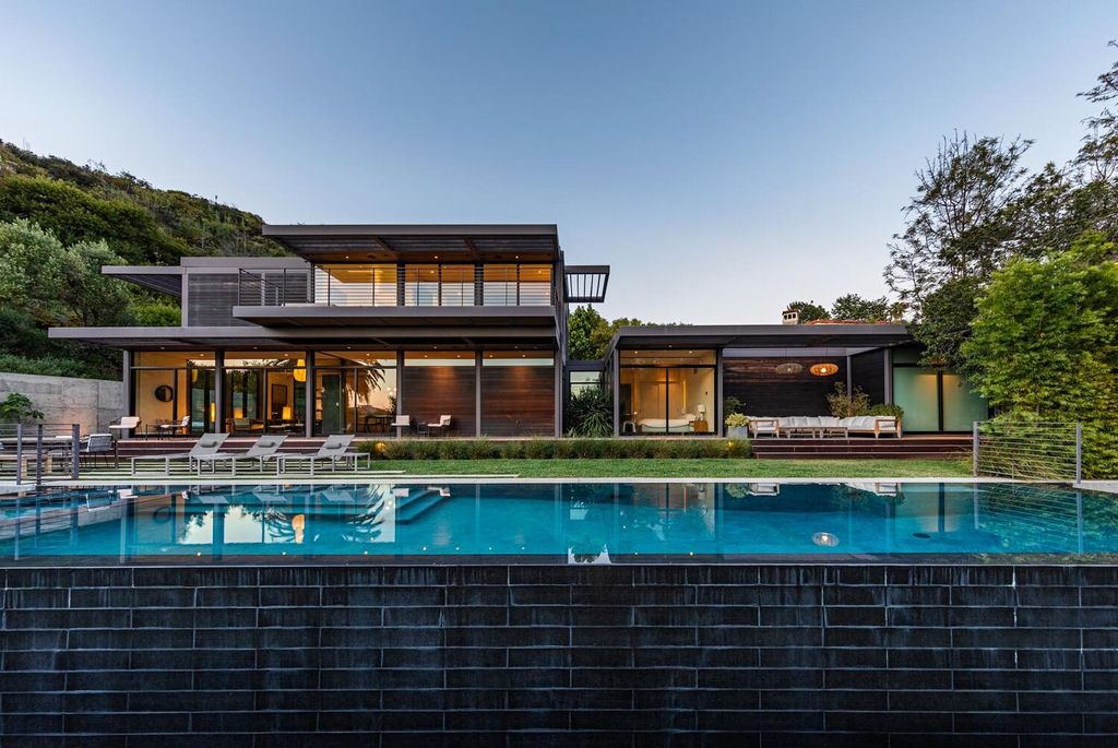 The Beverly Hills Home is a gated and secluded sanctuary with staggering vista views personifies quintessential California living now available for sale. This home located at 9321 Cherokee Ln, Beverly Hills, California; offering 5 bedrooms and 5 bathrooms with over 4,000 square feet of living spaces.