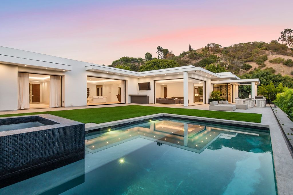 The Contemporary Home in Beverly Hills with panoramic views is built with soaring ceilings, clean lines, and sleek intricacies now available for sale. This home located at 1041 N Hillcrest Rd, Beverly Hills, California
