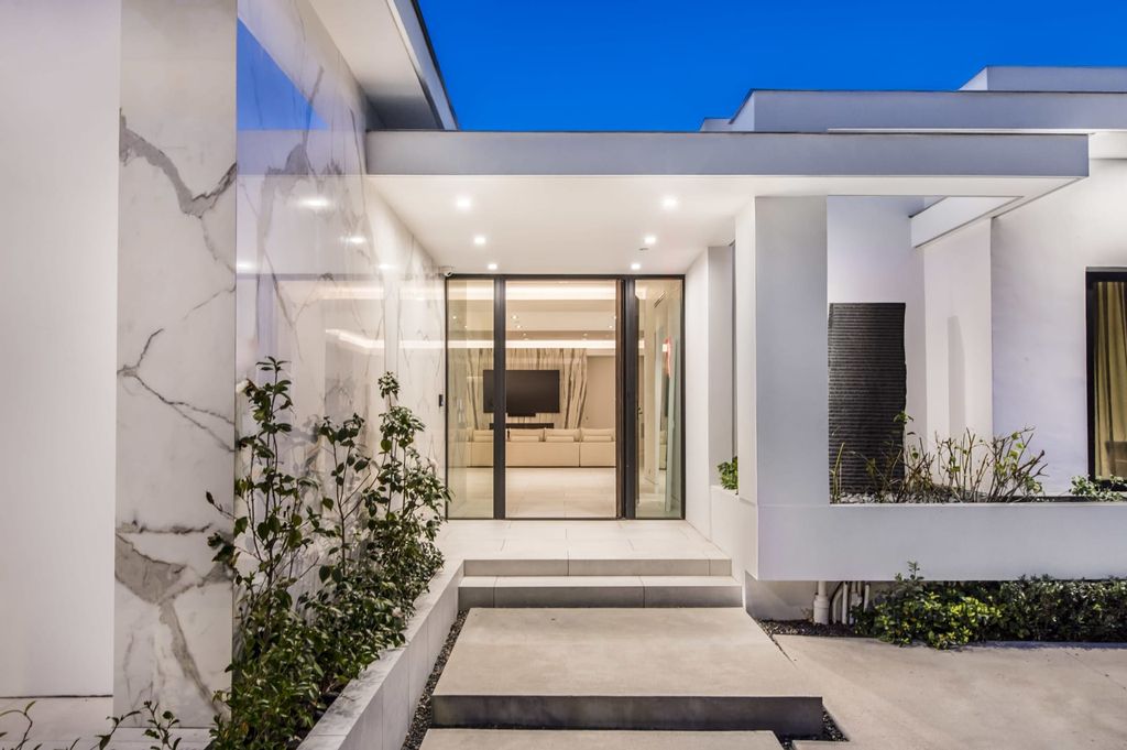 The Contemporary Home in Beverly Hills with panoramic views is built with soaring ceilings, clean lines, and sleek intricacies now available for sale. This home located at 1041 N Hillcrest Rd, Beverly Hills, California