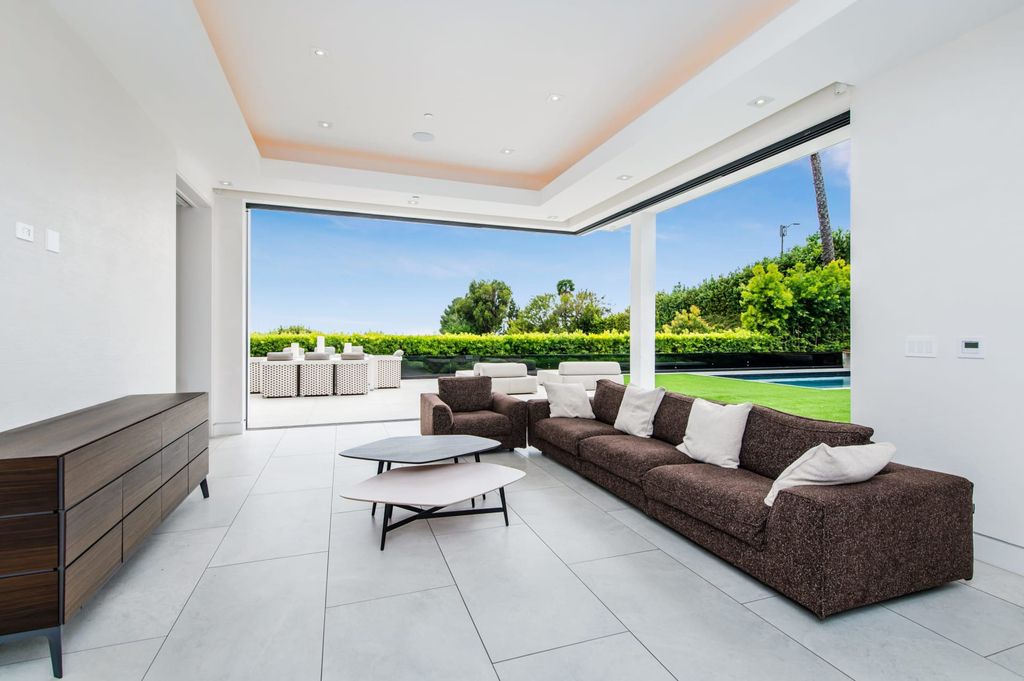 The Contemporary Home in Beverly Hills with panoramic views is built with soaring ceilings, clean lines, and sleek intricacies now available for sale. This home located at 1041 N Hillcrest Rd, Beverly Hills, California