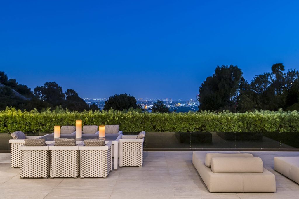 The Contemporary Home in Beverly Hills with panoramic views is built with soaring ceilings, clean lines, and sleek intricacies now available for sale. This home located at 1041 N Hillcrest Rd, Beverly Hills, California
