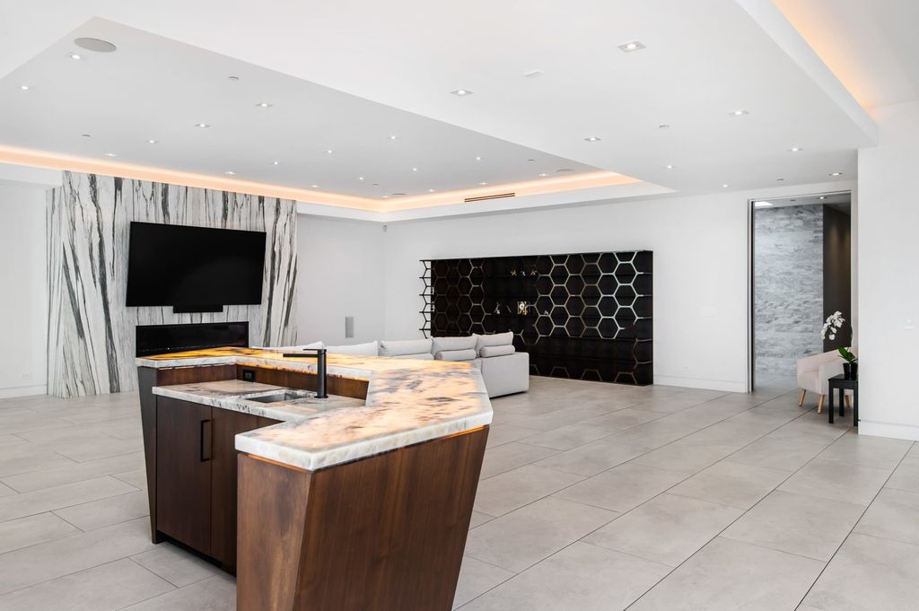 The Contemporary Home in Beverly Hills with panoramic views is built with soaring ceilings, clean lines, and sleek intricacies now available for sale. This home located at 1041 N Hillcrest Rd, Beverly Hills, California