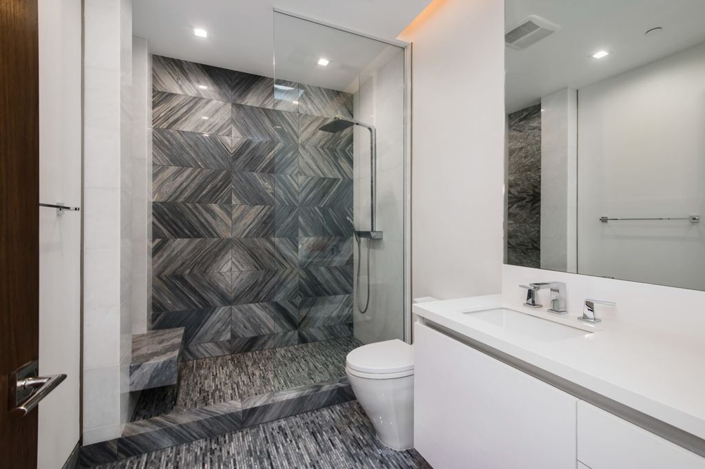 The Contemporary Home in Beverly Hills with panoramic views is built with soaring ceilings, clean lines, and sleek intricacies now available for sale. This home located at 1041 N Hillcrest Rd, Beverly Hills, California