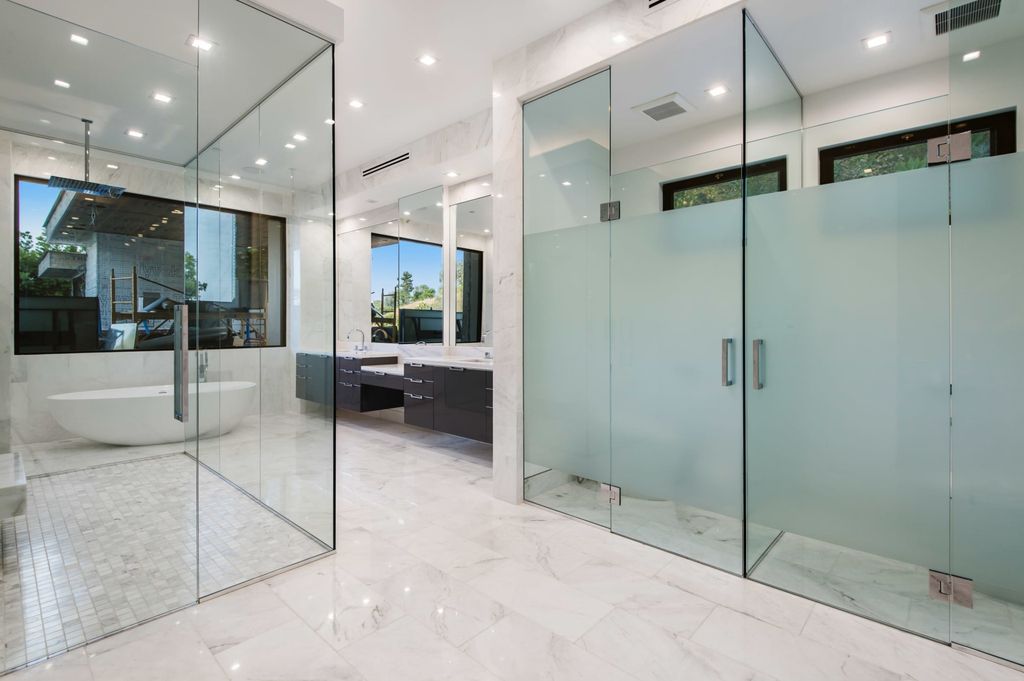 The Contemporary Home in Beverly Hills with panoramic views is built with soaring ceilings, clean lines, and sleek intricacies now available for sale. This home located at 1041 N Hillcrest Rd, Beverly Hills, California