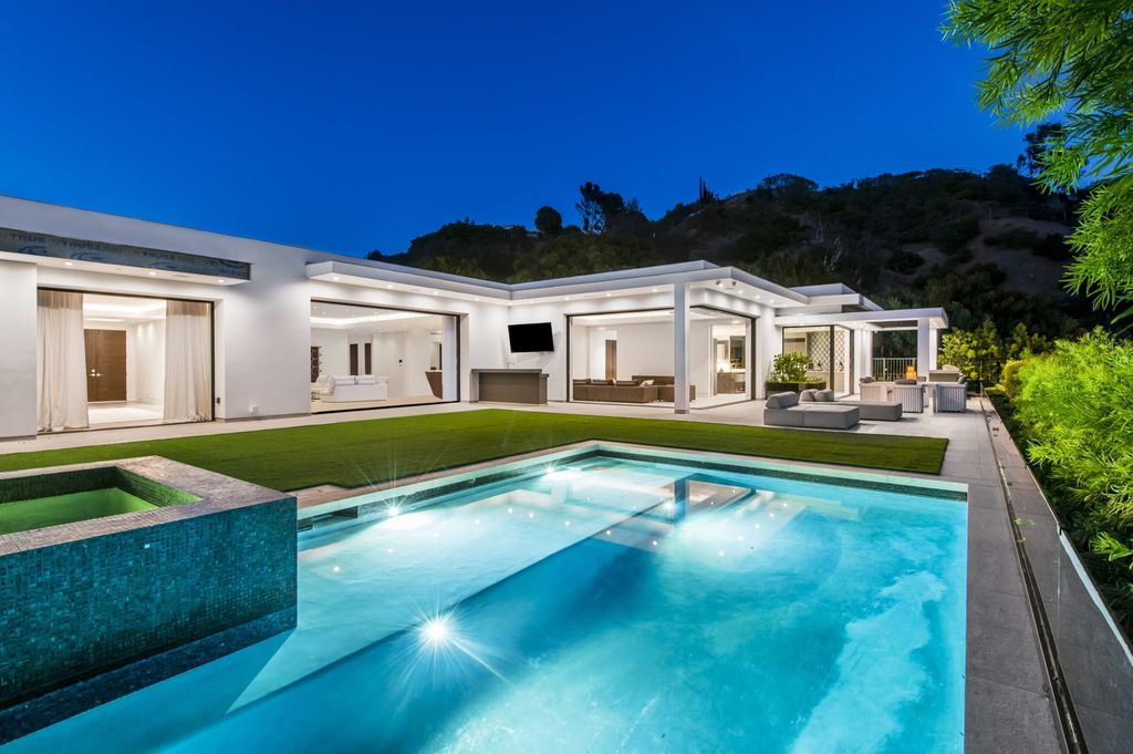 The Contemporary Home in Beverly Hills with panoramic views is built with soaring ceilings, clean lines, and sleek intricacies now available for sale. This home located at 1041 N Hillcrest Rd, Beverly Hills, California