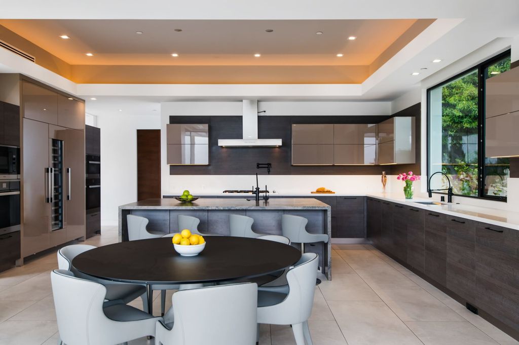 The Contemporary Home in Beverly Hills with panoramic views is built with soaring ceilings, clean lines, and sleek intricacies now available for sale. This home located at 1041 N Hillcrest Rd, Beverly Hills, California