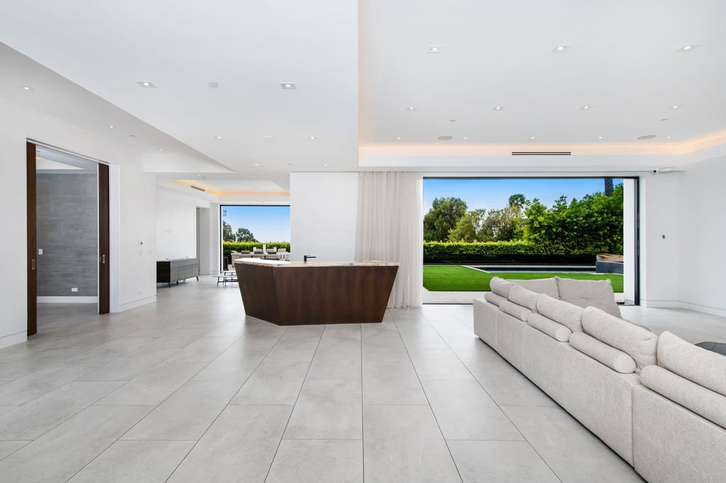 The Contemporary Home in Beverly Hills with panoramic views is built with soaring ceilings, clean lines, and sleek intricacies now available for sale. This home located at 1041 N Hillcrest Rd, Beverly Hills, California