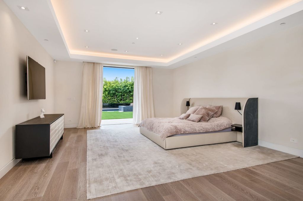 The Contemporary Home in Beverly Hills with panoramic views is built with soaring ceilings, clean lines, and sleek intricacies now available for sale. This home located at 1041 N Hillcrest Rd, Beverly Hills, California