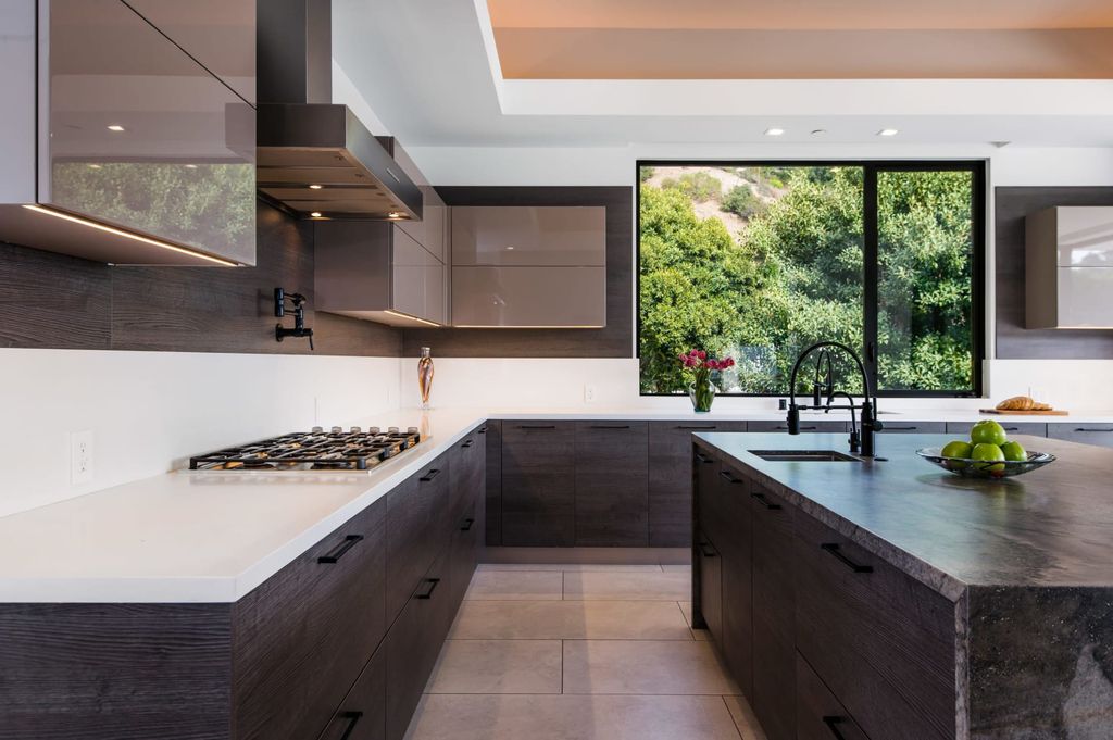 The Contemporary Home in Beverly Hills with panoramic views is built with soaring ceilings, clean lines, and sleek intricacies now available for sale. This home located at 1041 N Hillcrest Rd, Beverly Hills, California