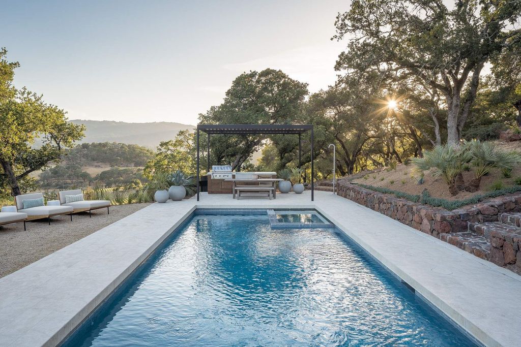 The Glen Ellen Modern Home is a 15-acre hillside Sonoma Valley property in a classic California setting with dramatic views now available for sale. This home located at 500 Aurora Ln, Glen Ellen, California