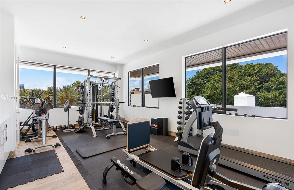This Mansion in Golden Beach is a modern tropical oasis is situated on a wide canal with breathtaking water views available for sale. This home located at 660 N Island, Golden Beach, Florida