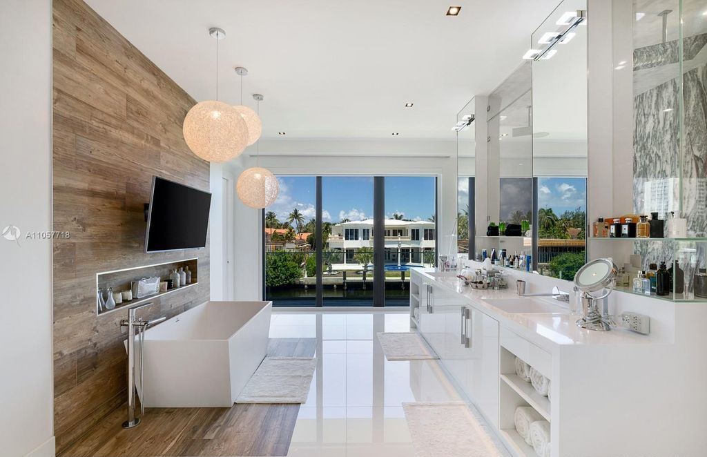 This Mansion in Golden Beach is a modern tropical oasis is situated on a wide canal with breathtaking water views available for sale. This home located at 660 N Island, Golden Beach, Florida