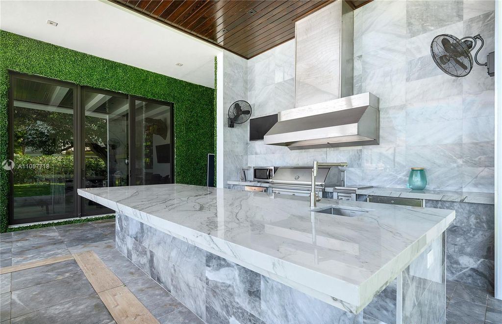 This Mansion in Golden Beach is a modern tropical oasis is situated on a wide canal with breathtaking water views available for sale. This home located at 660 N Island, Golden Beach, Florida