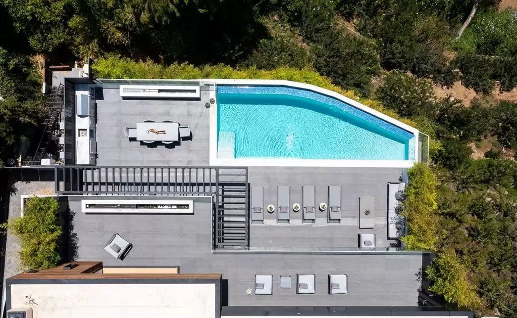 The Home in Hollywood Hills is a brand new contemporary masterpiece with unparalleled finishes and museum-quality materials now available for sale. This home located at 9410 Sierra Mar Pl, Los Angeles, California