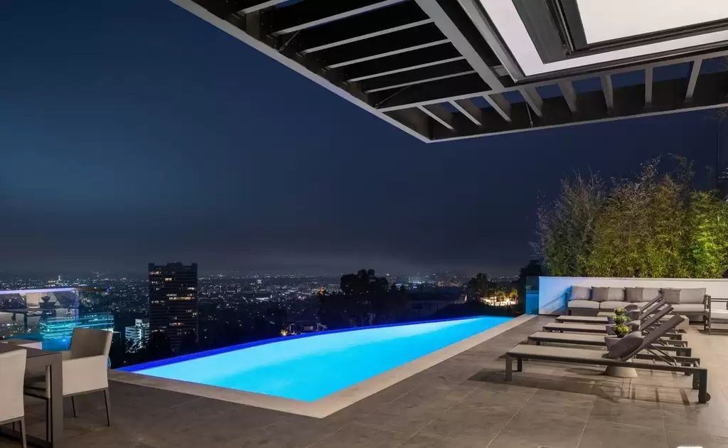 The Home in Hollywood Hills is a brand new contemporary masterpiece with unparalleled finishes and museum-quality materials now available for sale. This home located at 9410 Sierra Mar Pl, Los Angeles, California