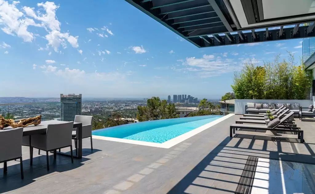 The Home in Hollywood Hills is a brand new contemporary masterpiece with unparalleled finishes and museum-quality materials now available for sale. This home located at 9410 Sierra Mar Pl, Los Angeles, California