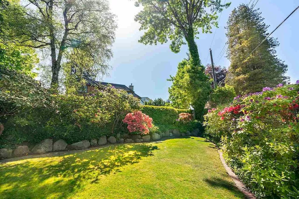 The Lovely House in Vancouver is surrounded by incredible gardens now available for sale. This home is located at 2588 Courtenay St, Vancouver, BC V6R 3X3, Canada
