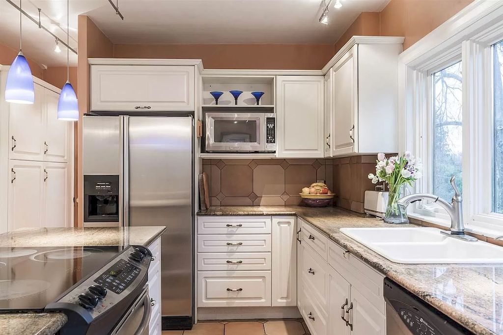 The Lovely House in Vancouver is surrounded by incredible gardens now available for sale. This home is located at 2588 Courtenay St, Vancouver, BC V6R 3X3, Canada
