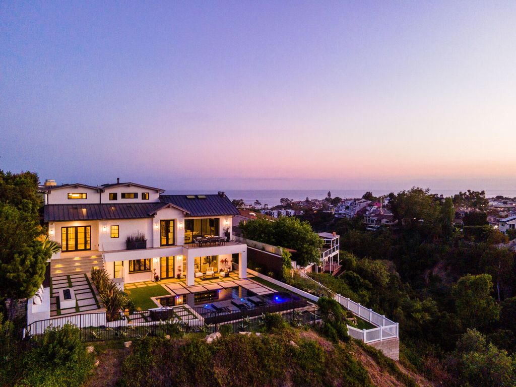 The Home in Corona Del Mar is a contemporary ocean view residence features sweeping ocean and Catalina views now available for sale. This home located at 409 De Sola Ter, Corona Del Mar, California