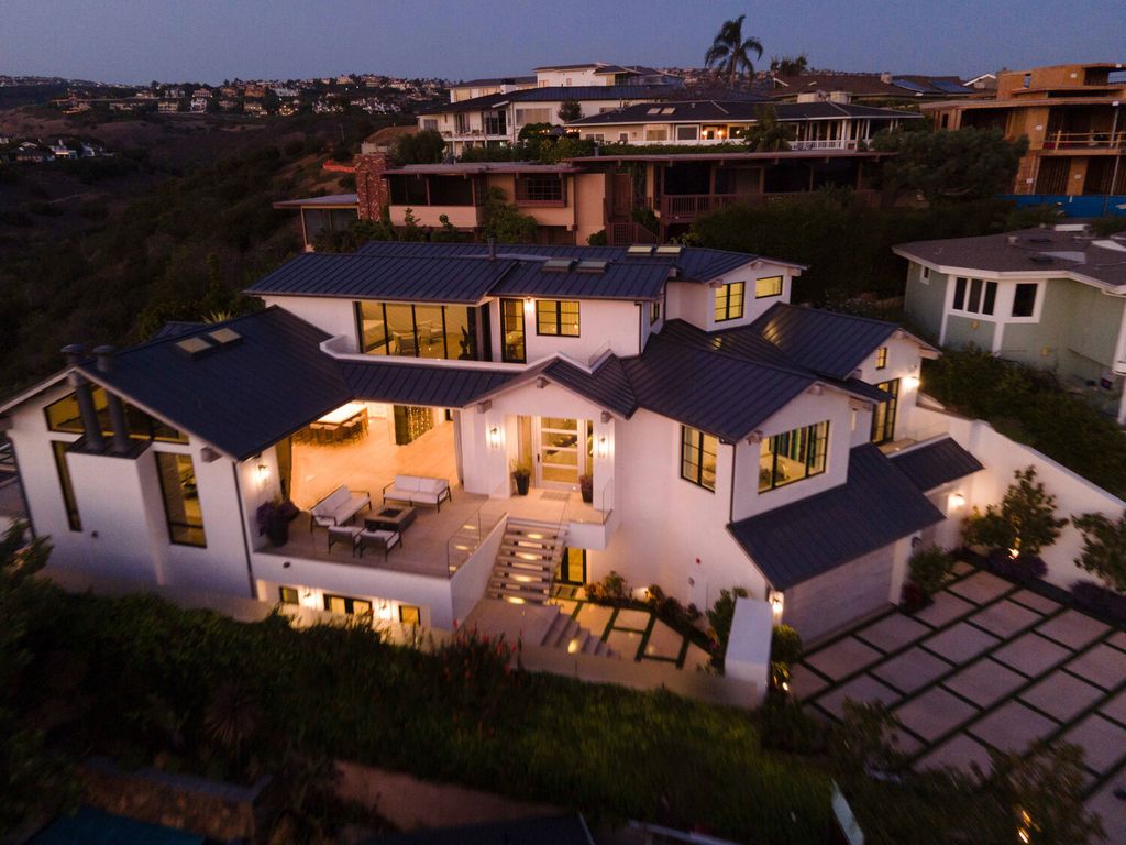 The Home in Corona Del Mar is a contemporary ocean view residence features sweeping ocean and Catalina views now available for sale. This home located at 409 De Sola Ter, Corona Del Mar, California