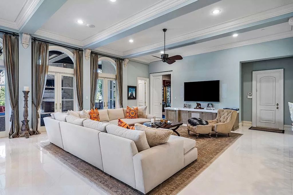The Boca Raton Home is a luxurious five-bedroom estate complemented by the refreshed decor, seamlessly blending clean lines and traditional elegance now available for sale. This home located at 1869 Sabal Palm Dr, Boca Raton, Florida