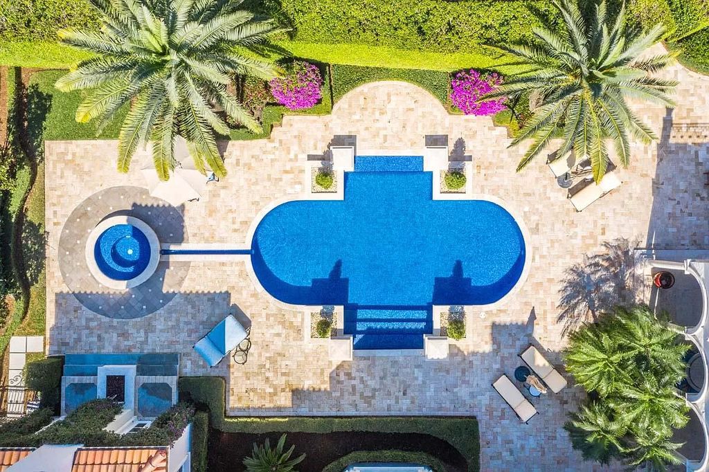The Boca Raton Home is a luxurious five-bedroom estate complemented by the refreshed decor, seamlessly blending clean lines and traditional elegance now available for sale. This home located at 1869 Sabal Palm Dr, Boca Raton, Florida